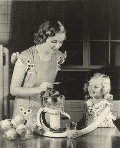 Mother and daughter use GE electric juicer.