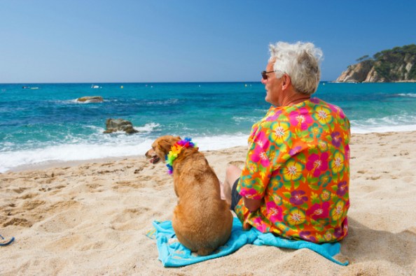 Senior man with dog on beach